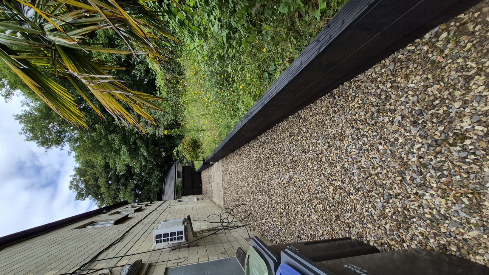 Side access path re-gravelled with new black sleeper edging