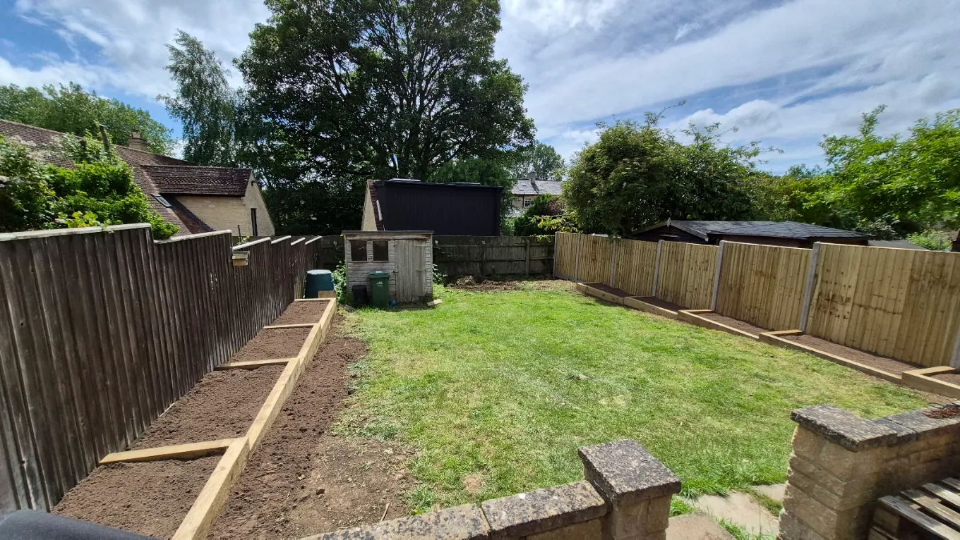 Sleeper borders built along a new fence line with the shed reset