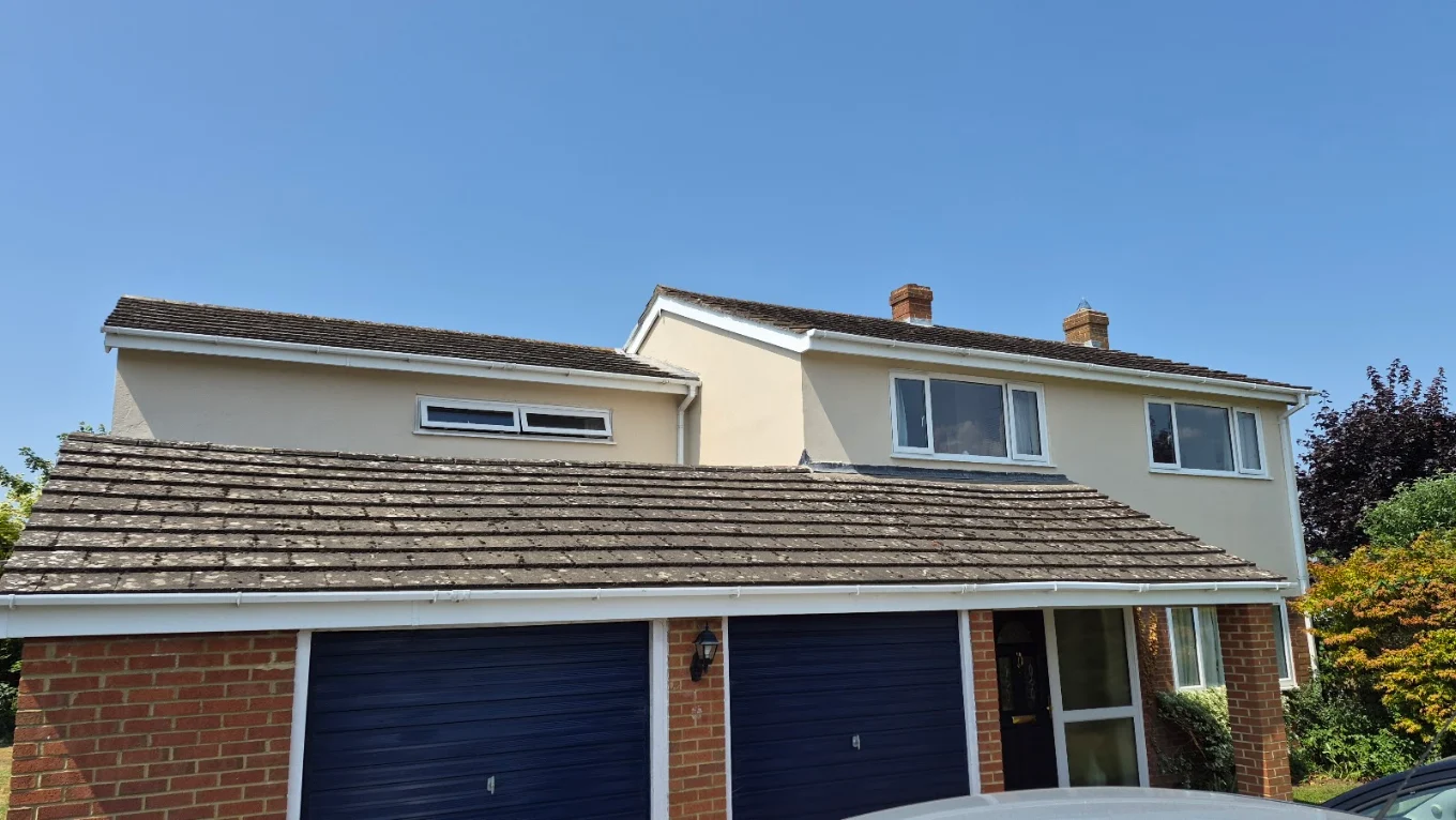 Rendered house exterior with new garage doors and roofline finished