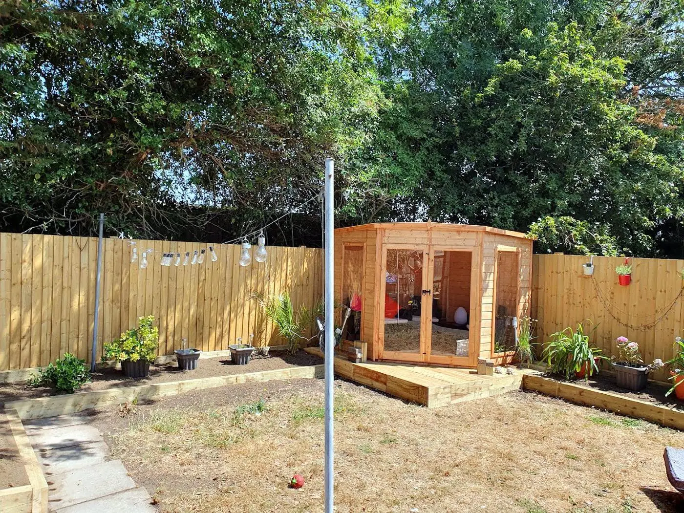 Corner summer house on a new decked base with fresh fencing