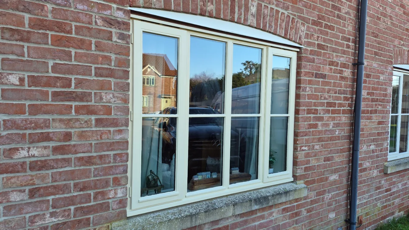 New casement window fitted and sealed into a brick elevation