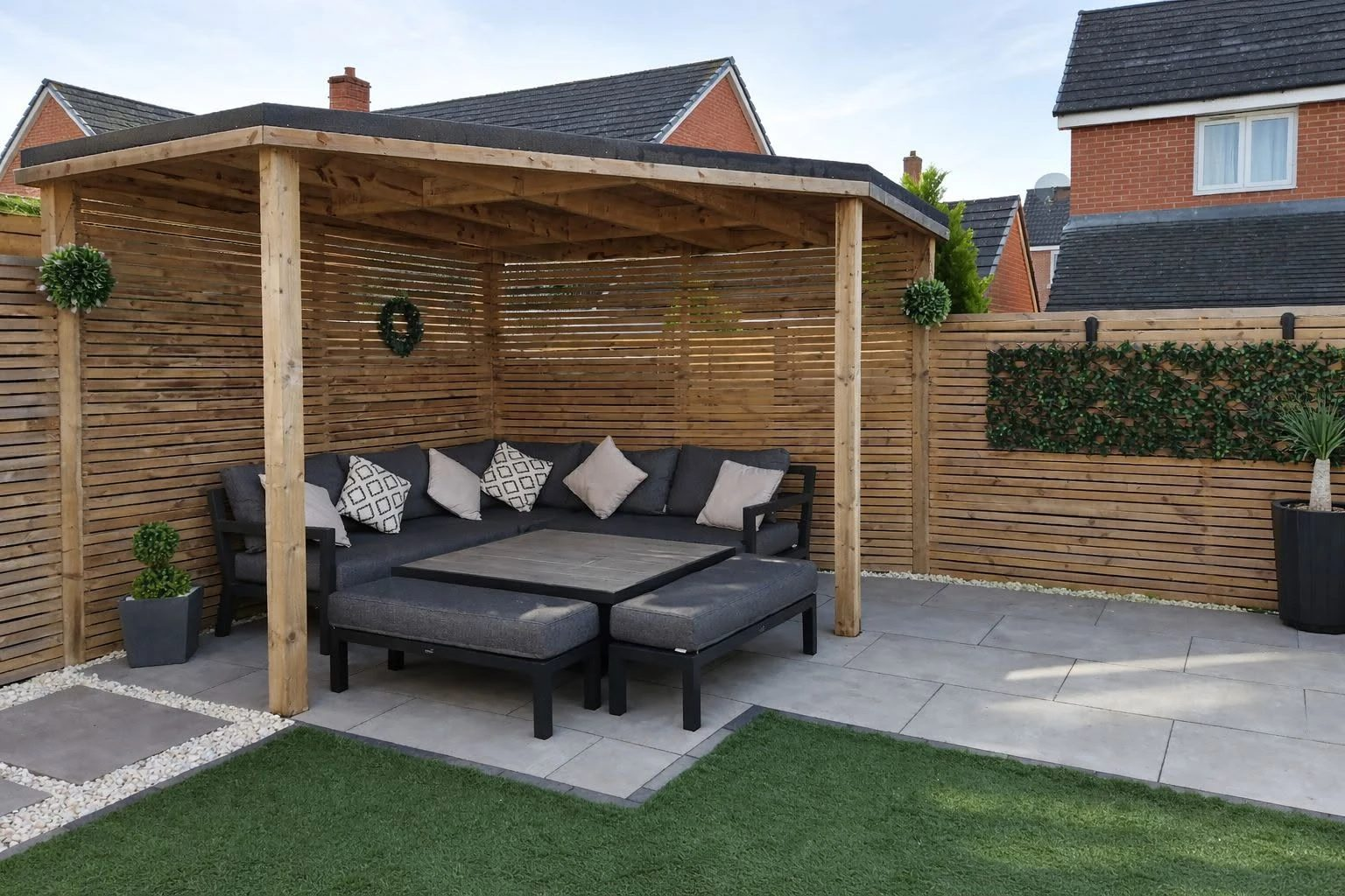 Timber pergola with corner seating over a paved patio