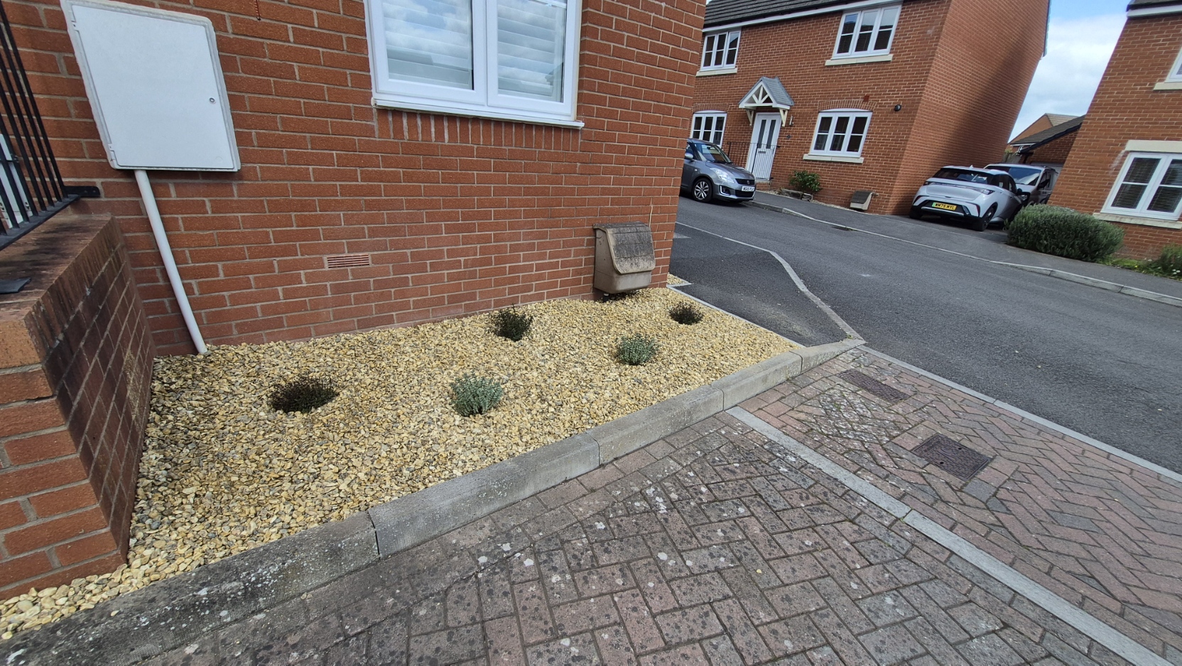 Front gravel bed weeded, re-stoned and replanted
