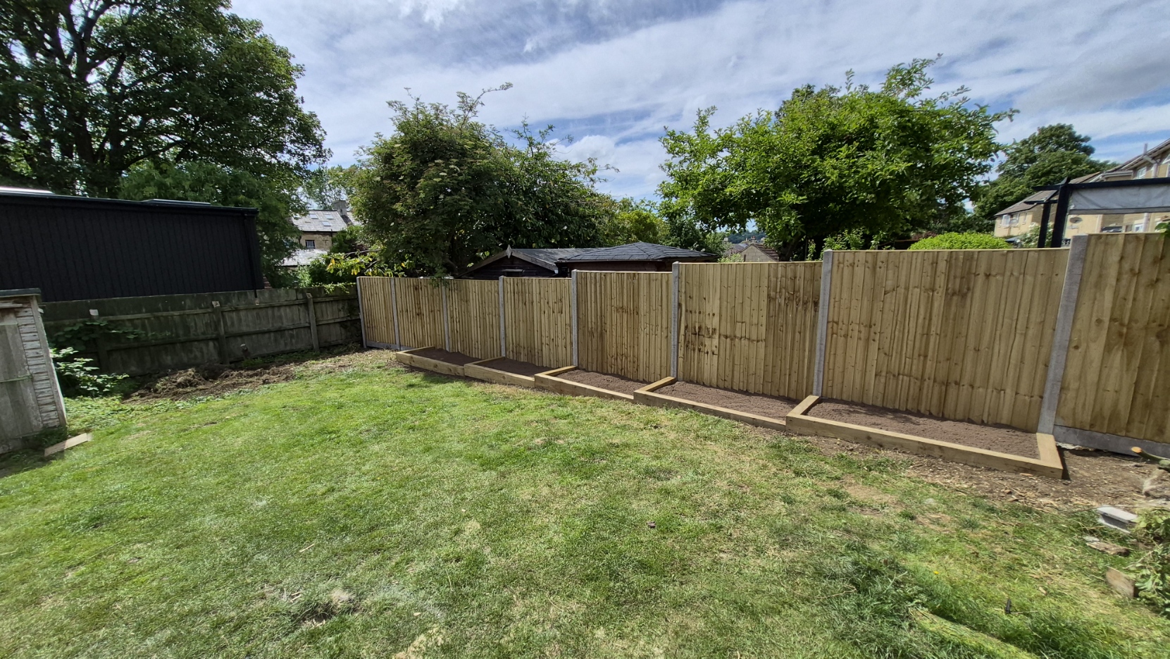 New close board fencing with sleeper edged planting borders